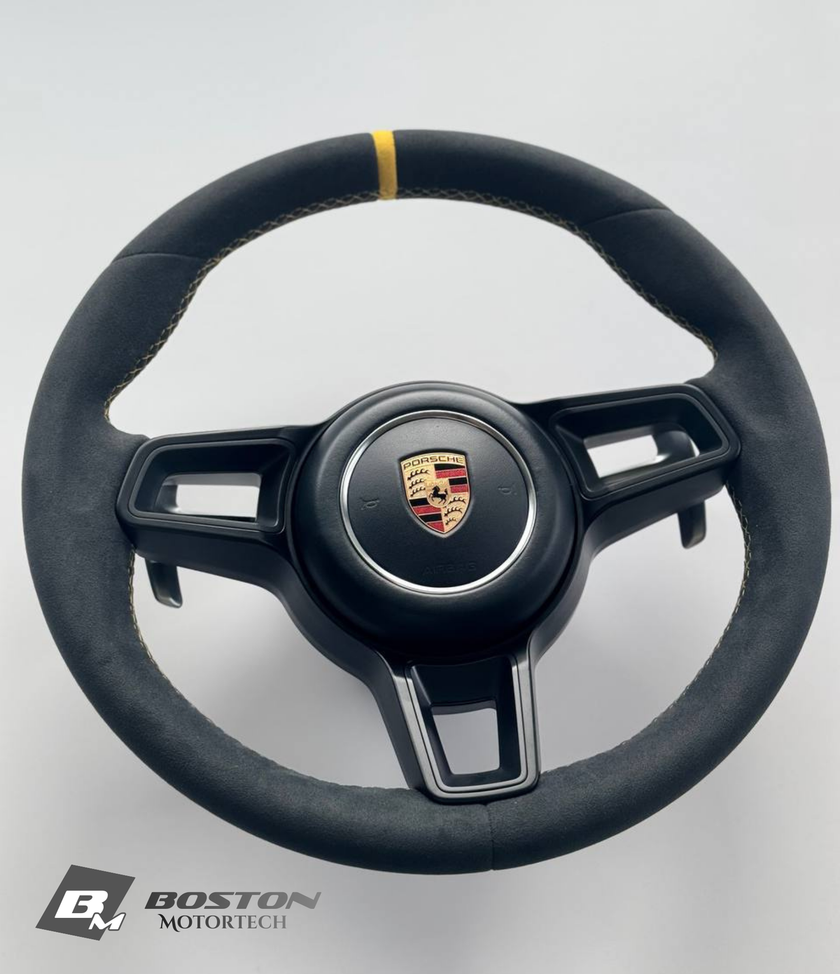 Genuine Porsche 991.2 steering wheel full set in yellow with Boston Motortech branding, showing the textured grip and control buttons.
