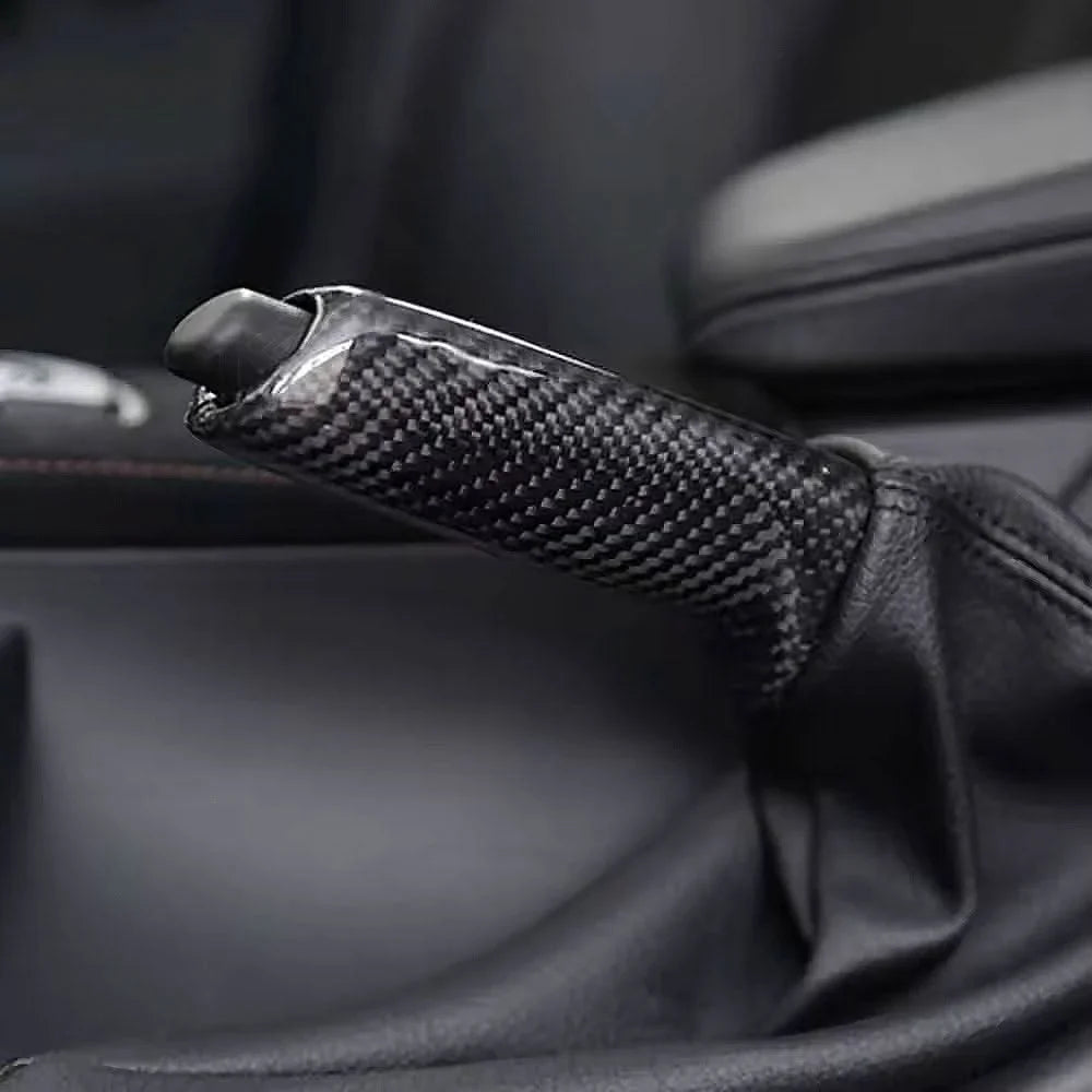 BMW carbon fiber handbrake lever cover by K2 Industries, showing sleek black carbon fiber material on a handbrake lever.