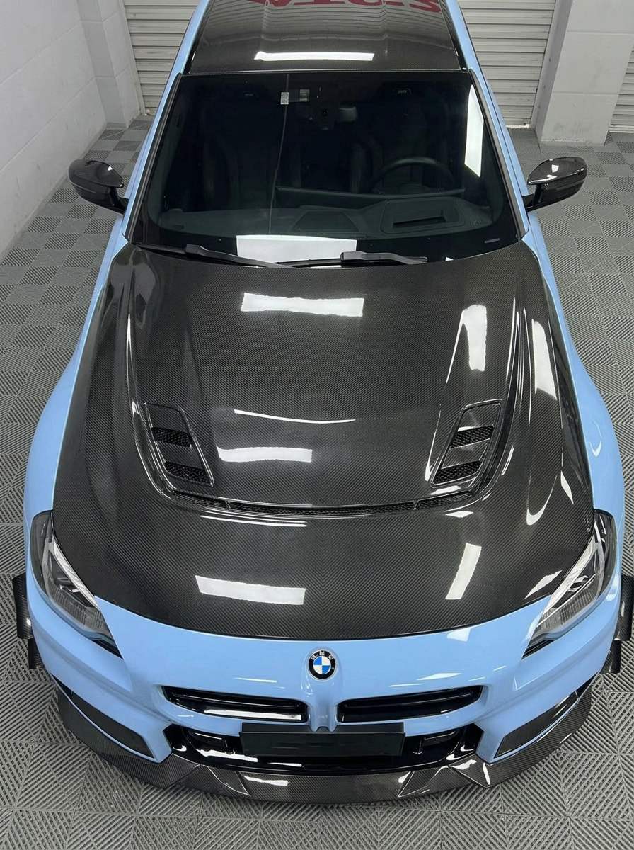 K2 Industries BMW 2 Series G87 M2 2023+ carbon fiber hood showing sleek, lightweight carbon fiber with aerodynamic design.