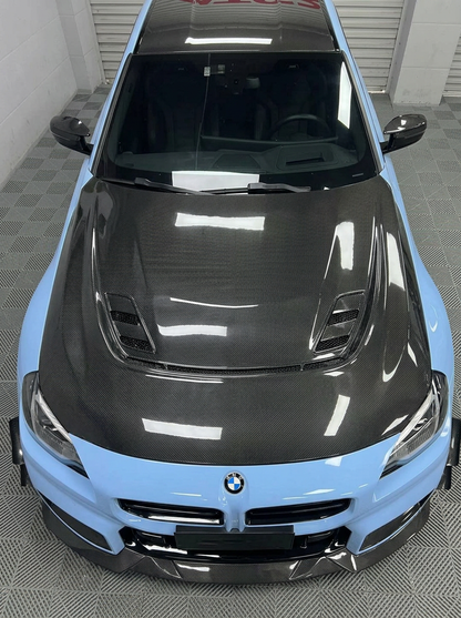 K2 Industries BMW 2 Series G87 M2 2023+ carbon fiber hood showing sleek, lightweight carbon fiber with aerodynamic design.