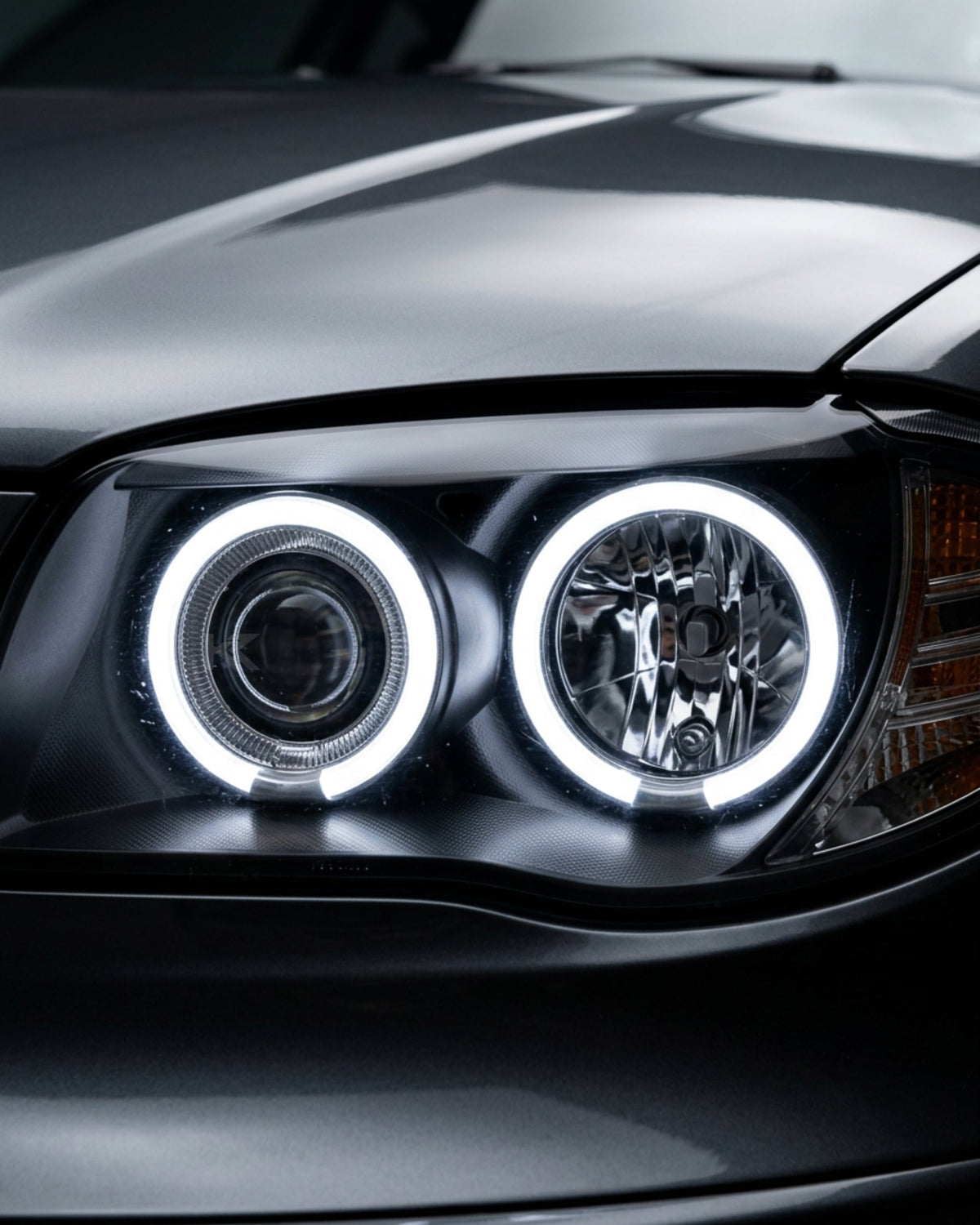 BMW 1 Series 120i 118i E87 Angel Eyes LED headlights by K2 Industries, showing sleek design with bright LED rings on a car.