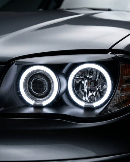 BMW 1 Series 120i 118i E87 Angel Eyes LED headlights by K2 Industries, showing sleek design with bright LED rings on a car.