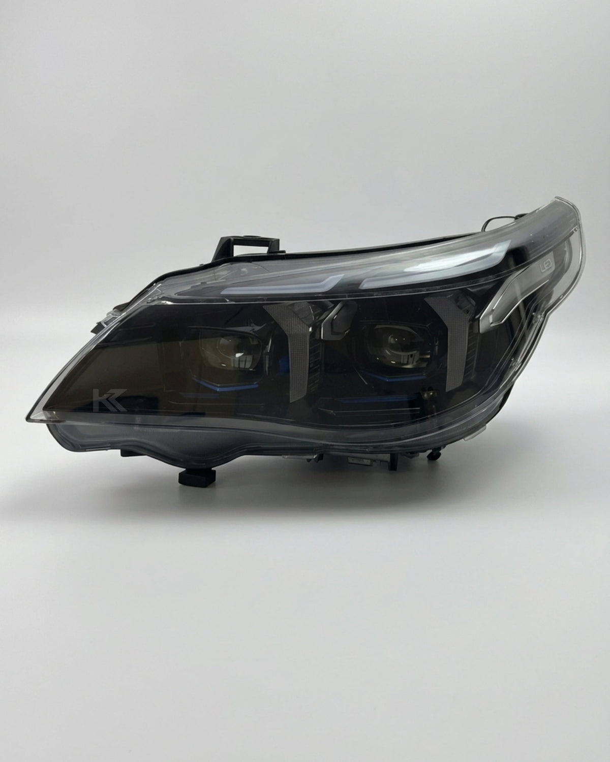 BMW 5 Series E60 Snake Eye LED headlight assembly with dual-color daytime running lights, showcasing the sleek front design.