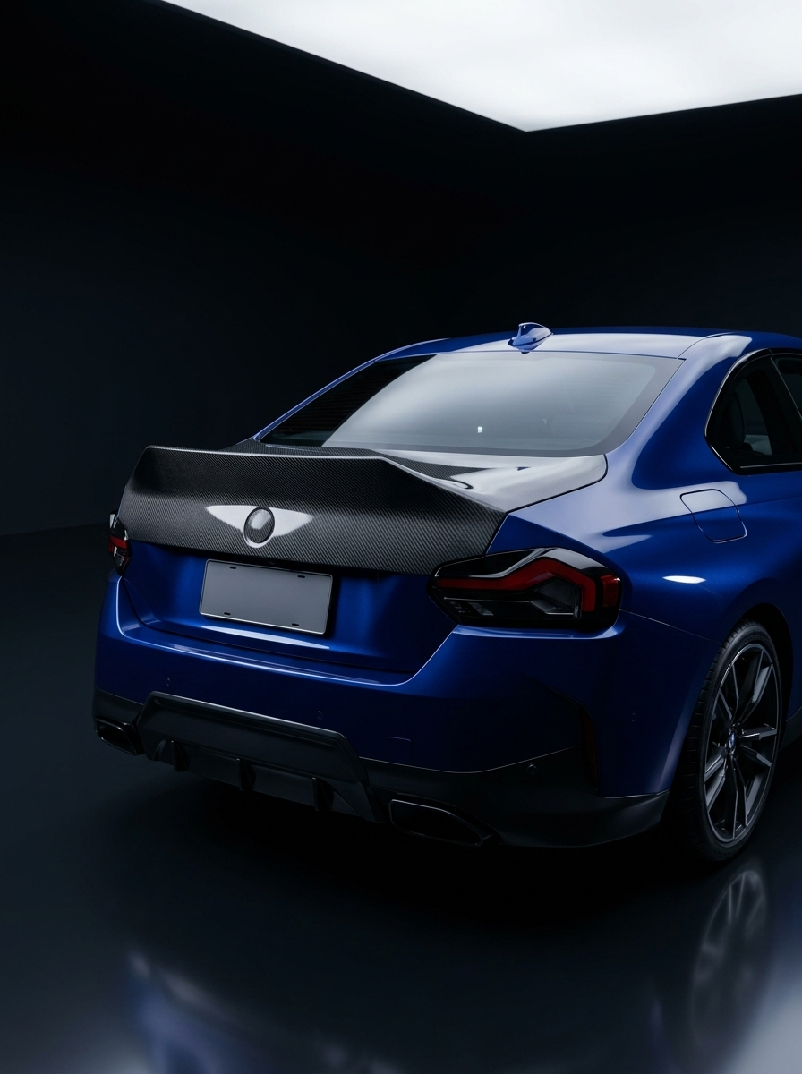 BMW 2 Series G42 M240i CSL dry carbon fiber trunk by K2 Industries, showcasing sleek carbon fiber design on the car's rear.