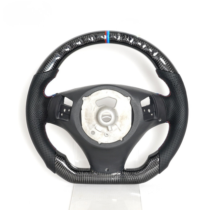 Vekto carbon fiber steering wheel for BMW E90 E92 E93 2009-2020, close-up view showing textured carbon fiber surface.