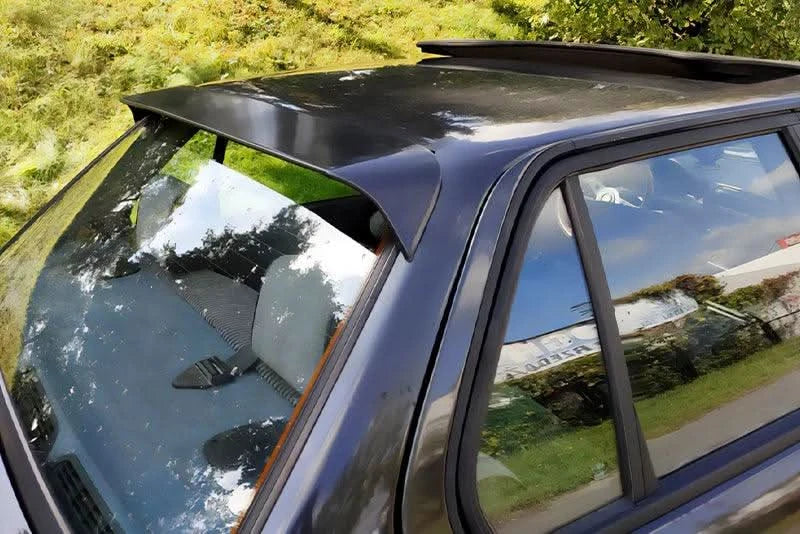 BMW E30 3 Series roof spoiler by K2 Industries, black aerodynamic spoiler mounted on the car's roof for sporty appearance.