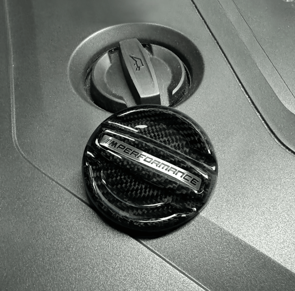 BMW MPerformance carbon fiber engine oil cover by K2 Industries, showcasing a sleek, lightweight carbon fiber engine oil cap.