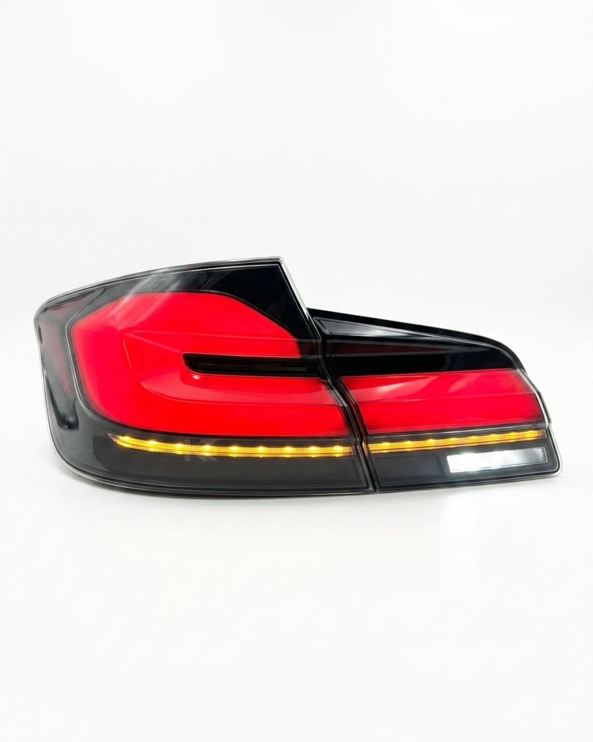 BMW 5-Series F10 F18 clear tail lights in G30 style, manufactured by K2 Industries, with red and clear lens design.
