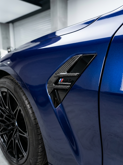 BMW 3/4 Series G80/G81/G82/G83 carbon fiber fender vents by K2 Industries, showing sleek, textured vent details on the car's front fenders