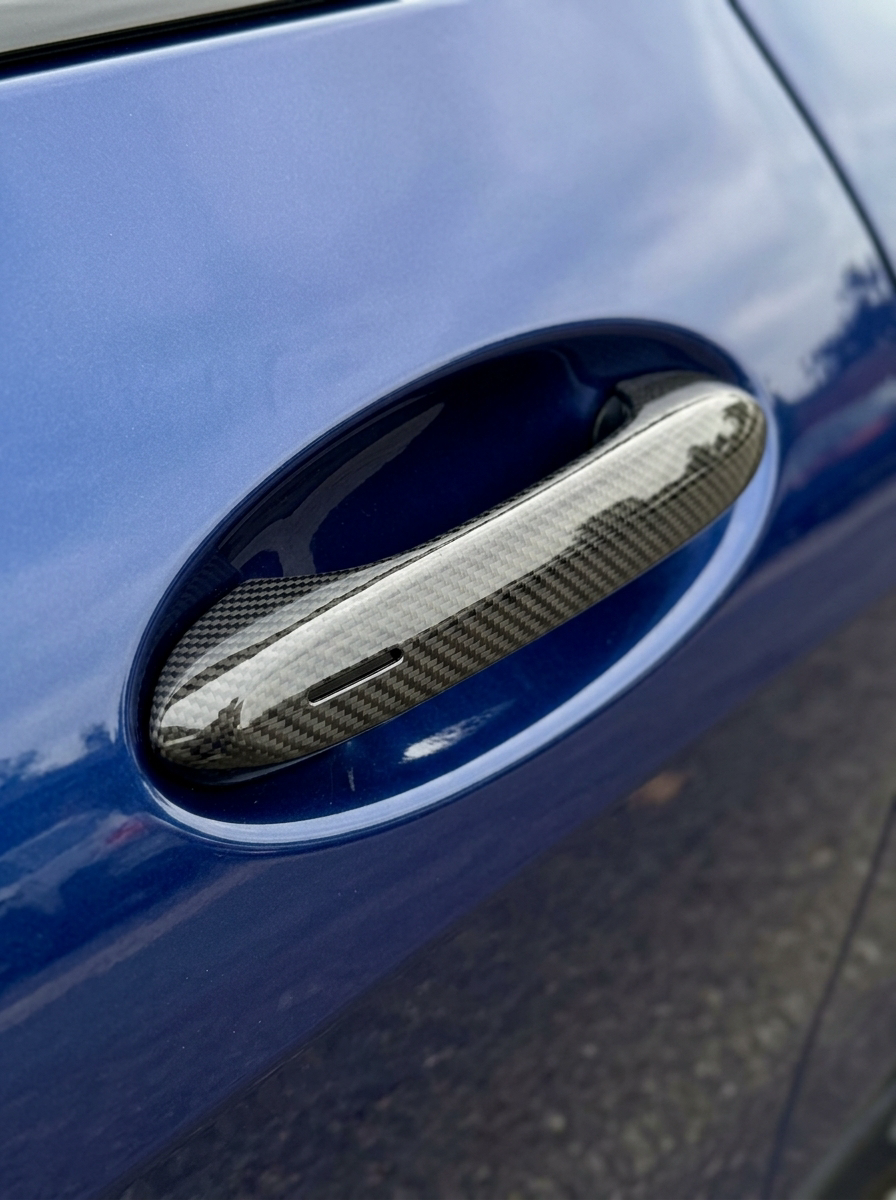 BMW 4 Series G82 M4 carbon fiber door handle cover by K2 Industries, featuring sleek black finish and precise fit for 2021+ models.