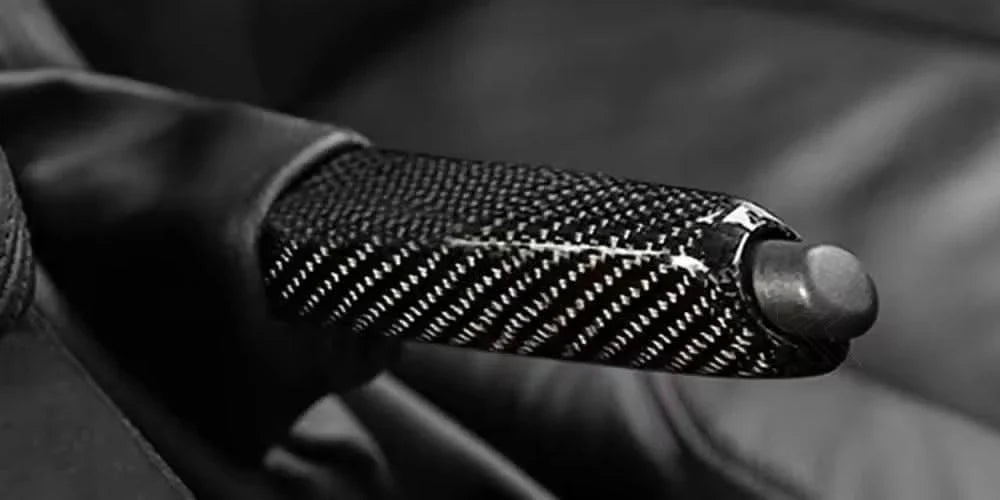 BMW carbon fiber handbrake lever cover by K2 Industries, showcasing a sleek, high-quality carbon fiber finish on the hand brake lever.