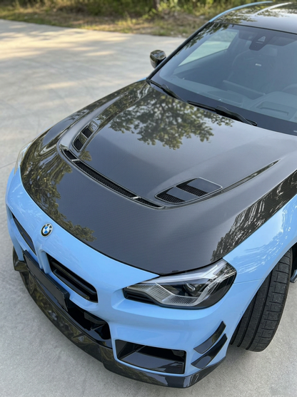BMW 2 Series G87 M2 carbon fiber hood by K2 Industries, showing the sleek, lightweight carbon fiber surface and aerodynamic design.