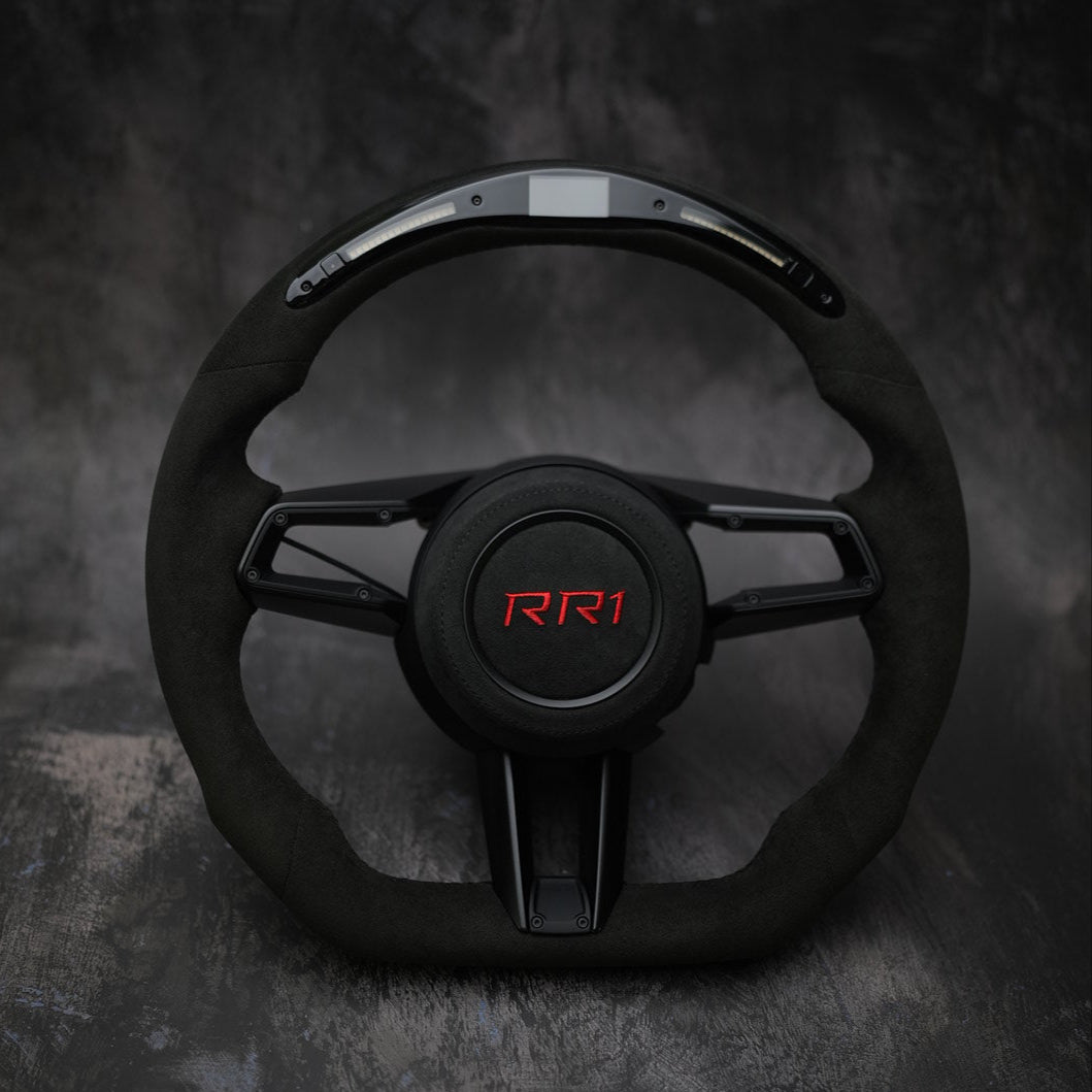 Custom steering wheel for Porsche 911 (992), Taycan, and Macan by Exclusive Steering, shown with detailed leather and stitching.