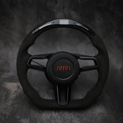 Custom steering wheel for Porsche 911 (992), Taycan, and Macan by Exclusive Steering, shown with detailed leather and stitching.