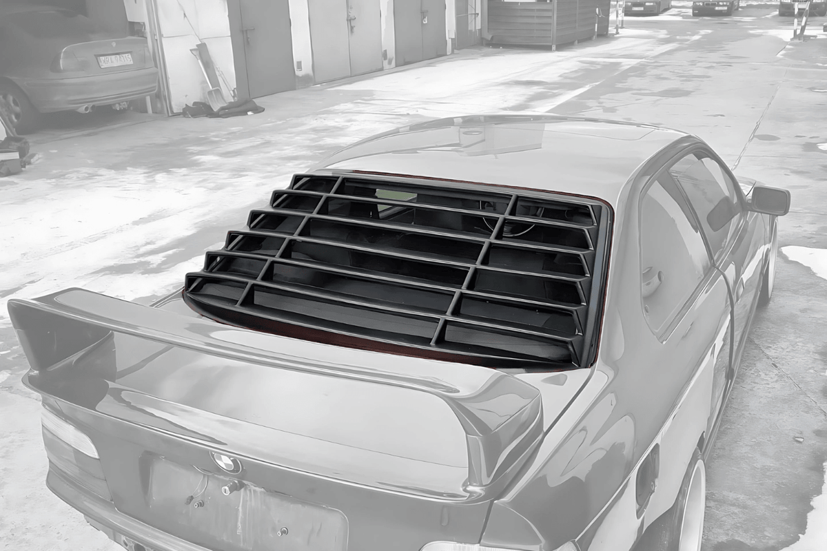 Black K2 Industries windshield louvers installed on a BMW E36 Coupe Series 3, 1992-1999, showcasing their sleek design and fit.