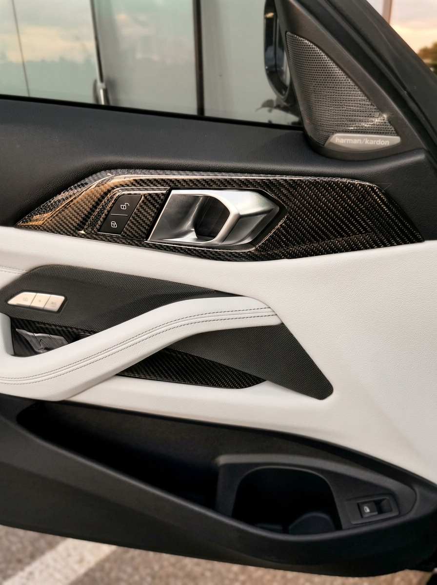 BMW 4 Series G82 G22 carbon fiber interior door trim set by K2 Industries, showcasing sleek, textured carbon fiber panels inside the car.