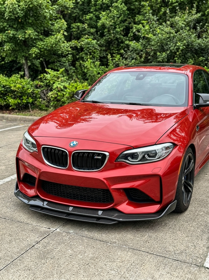 BMW 2 Series F87 M2 carbon fiber front lip by K2 Industries, designed for 2016-2019 models, shows sleek aerodynamic styling.