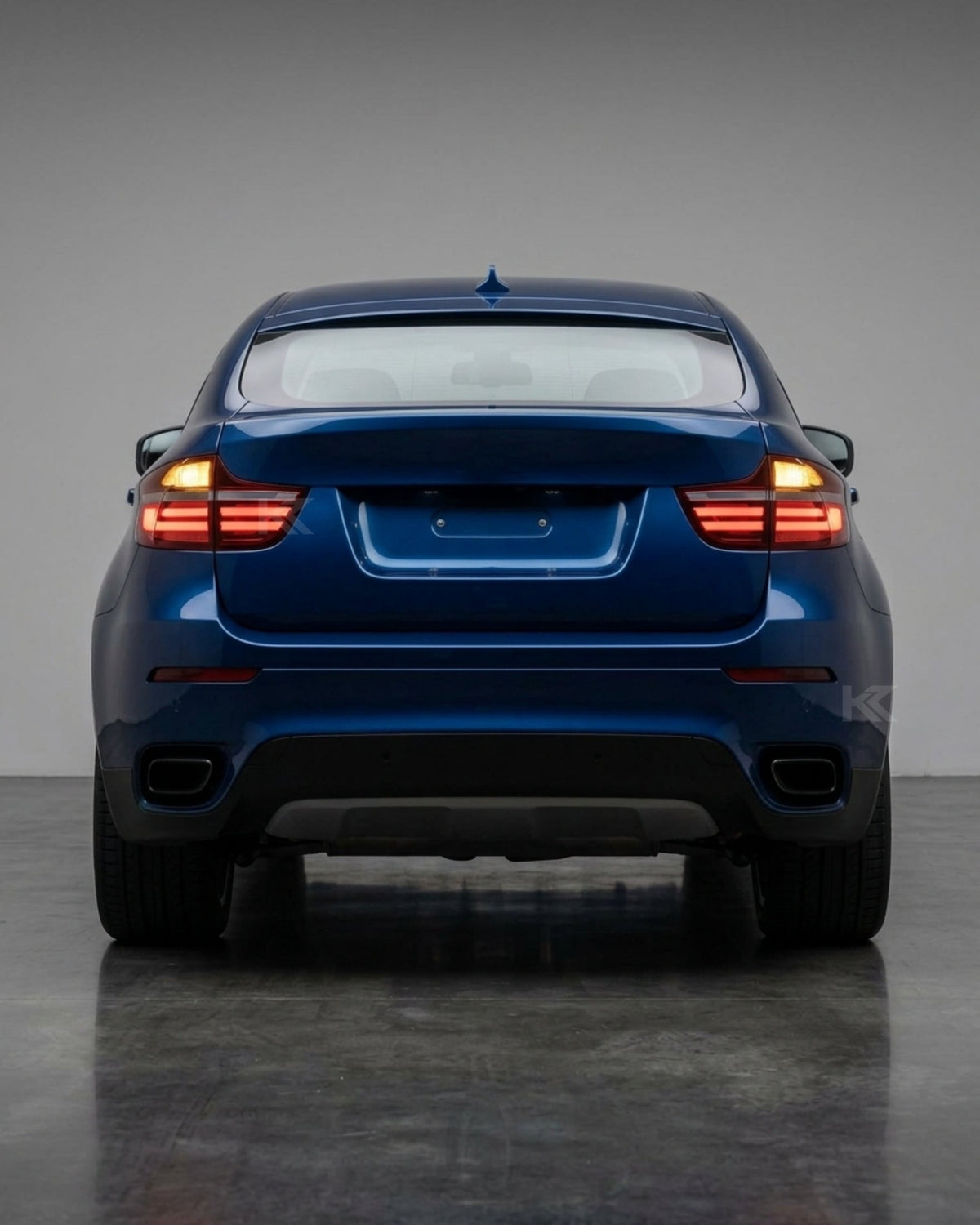 BMW X6 E71 tail lights with red and smoked LED upgrade by K2 Industries, showing the rear of the vehicle with illuminated LED tail lights.