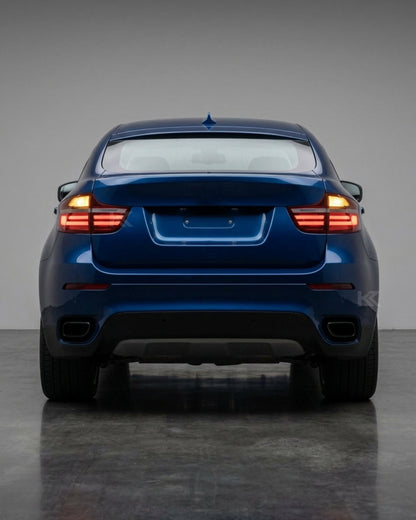 BMW X6 E71 tail lights with red and smoked LED upgrade by K2 Industries, showing the rear of the vehicle with illuminated LED tail lights.