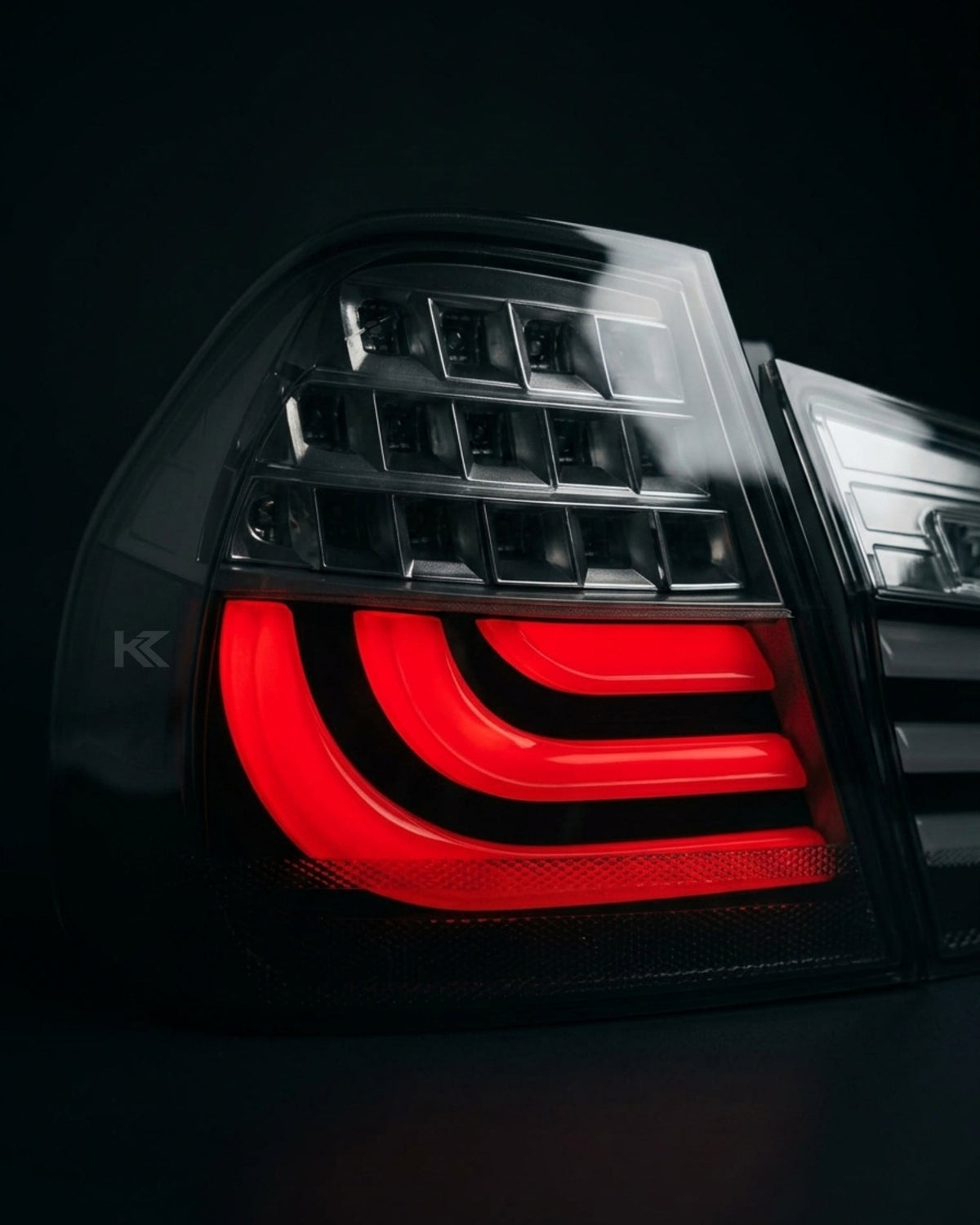 BMW 3 Series E90 upgraded LED tail light assembly by K2 Industries, showing bright red and clear lens details.