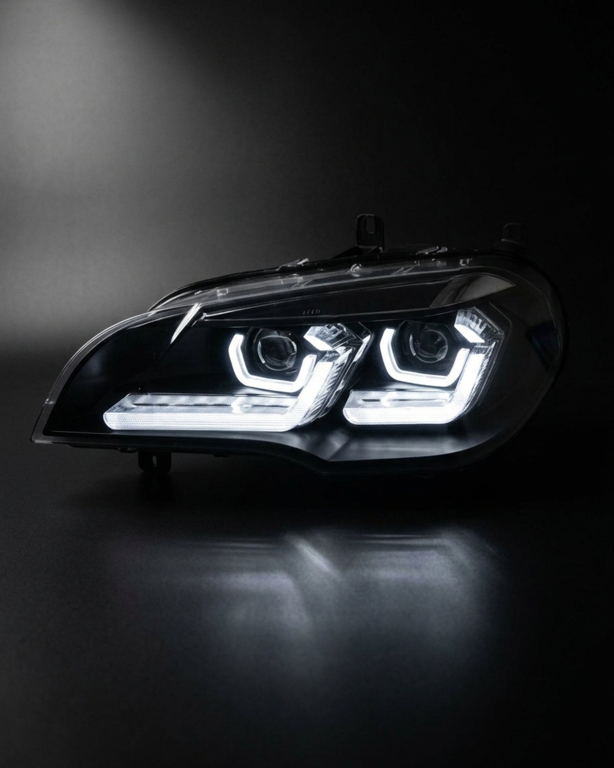 BMW X5 E70 headlights with K2 Industries LED "TRON" design, showing the sleek front view with LED accents and clear lenses.