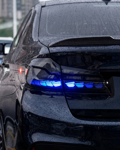 BMW 5-Series G30 G38 LED flow tail lights by K2 Industries showing sleek red and clear lens design on a black vehicle.