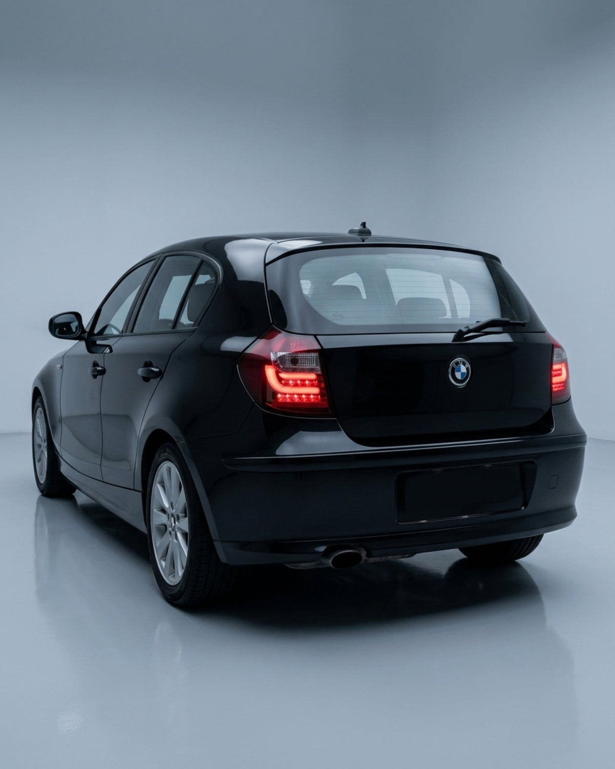 BMW 1 Series E87 E81 120i 130i LED tail light upgrade by K2 Industries, showing close-up of sleek red and clear LED tail lights.