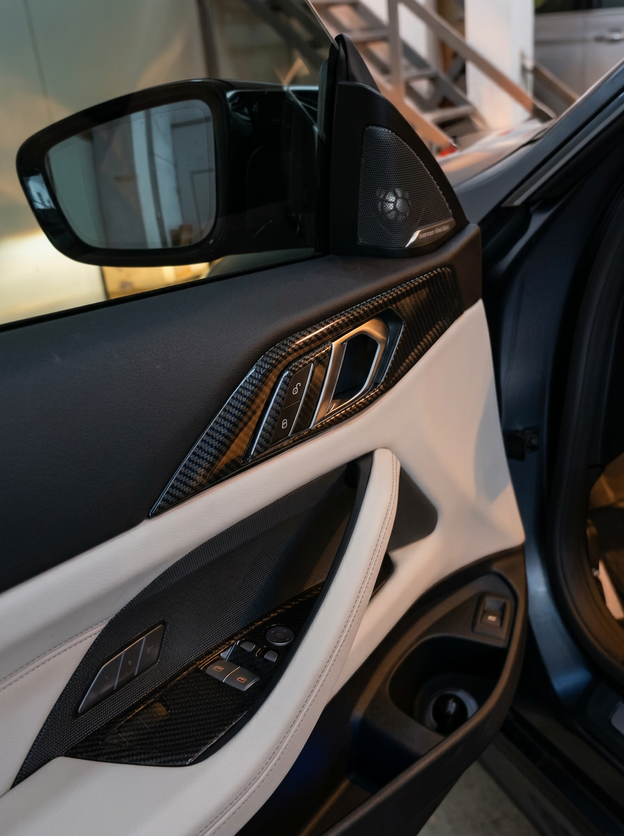 BMW 4 Series G82 G22 carbon fiber interior door trim set by K2 Industries, featuring sleek, textured black carbon fiber accents.