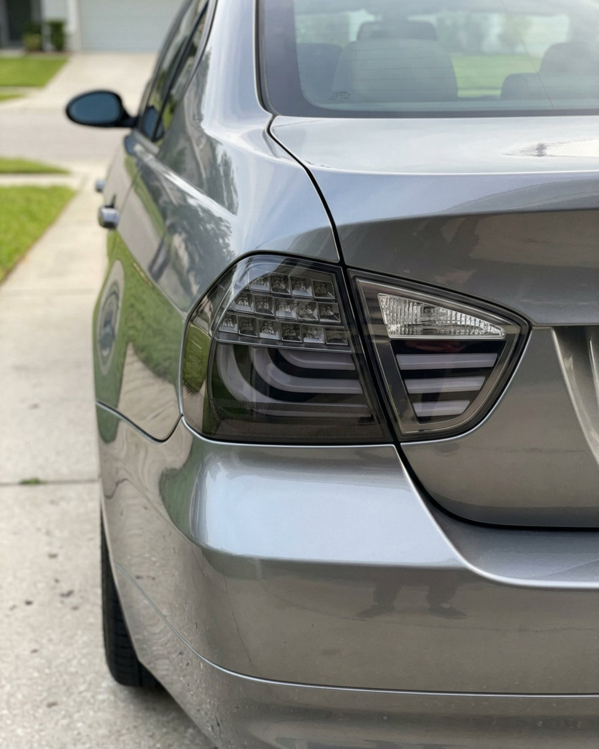 BMW 3-Series E90 tail light upgrade by K2 Industries showing a close-up of the sleek red and clear tail light assembly.