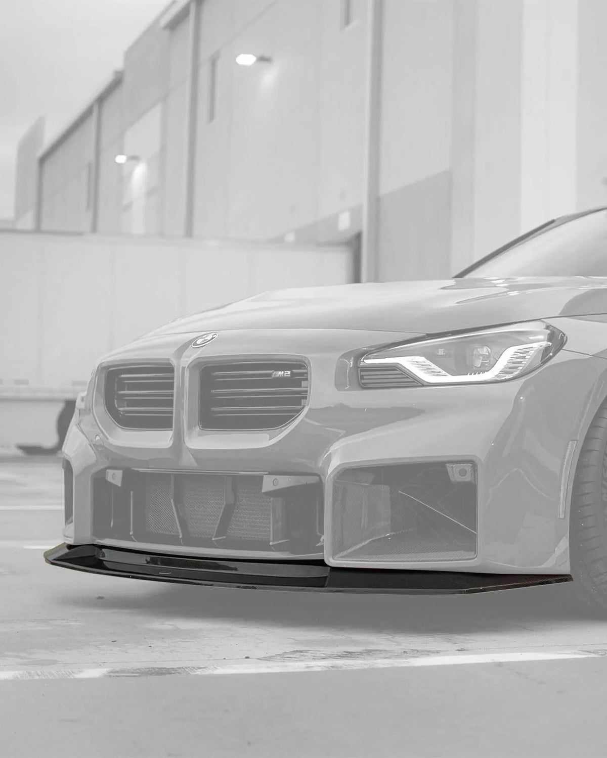 BMW 2 Series G87 M2 MHC Style carbon fiber front lip by K2 Industries, showcasing a sleek, aerodynamic design for 2023+ models.