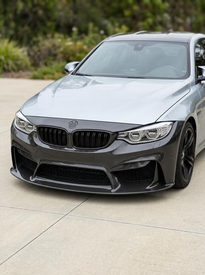 BMW 3 Series F80 F82 F83 carbon fiber front bumper by K2 Industries, showing the detailed aerodynamic design and glossy finish.