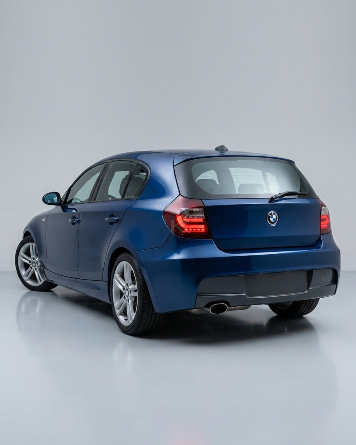 BMW 1 Series E87 E81 120i 130i LED tail light upgrade by K2 Industries, showing sleek red and clear lens tail lights.
