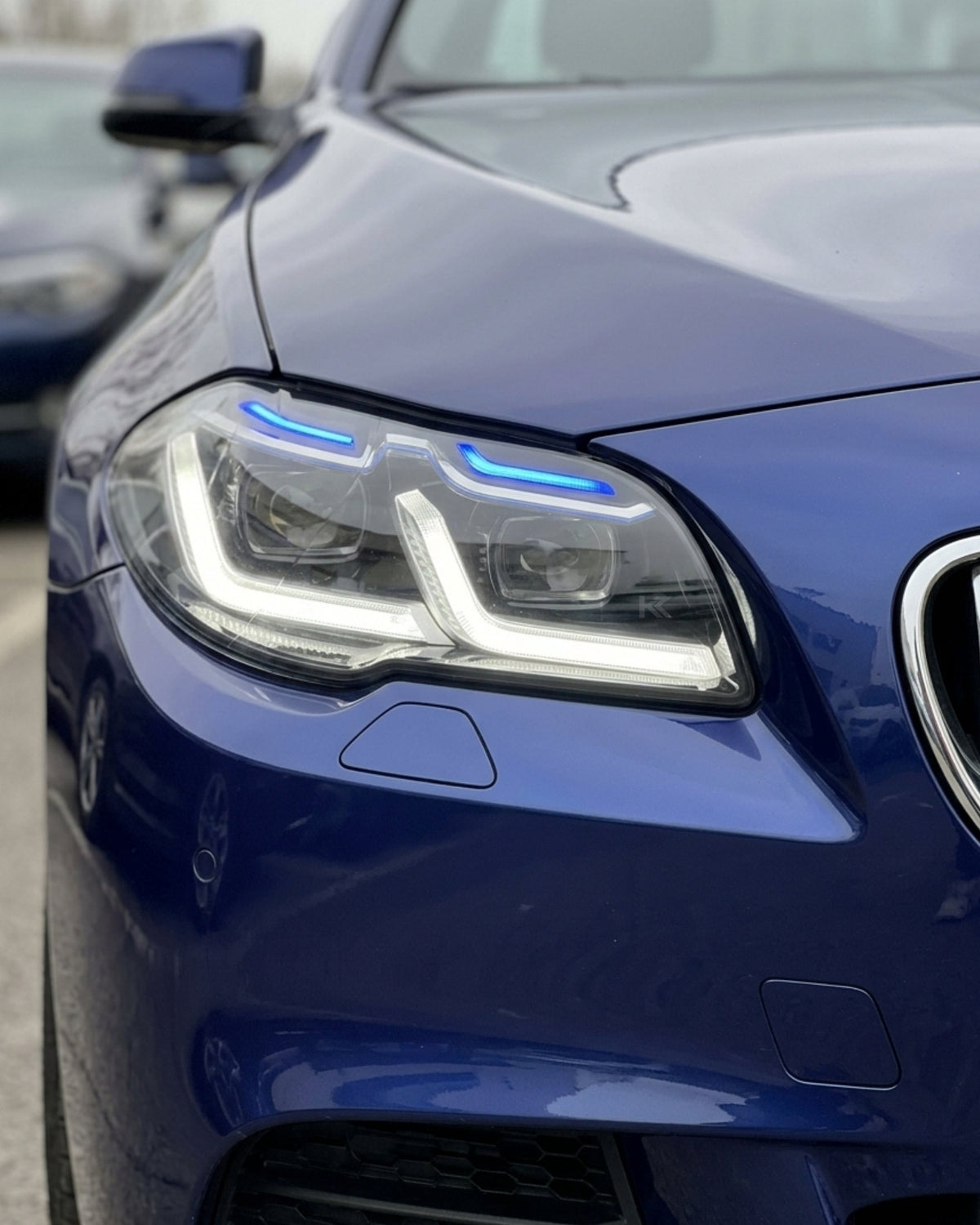 BMW 5-Series F10/F18 headlights with G30 style design by K2 Industries, showing clear lens and modern lighting elements.