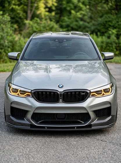 BMW 5 Series G30 carbon fiber front grille by K2 Industries, showcasing the sleek, textured carbon fiber design on the vehicle front.