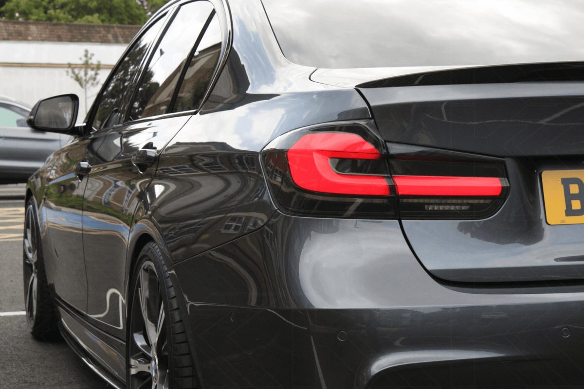 BMW 3 Series F30 F35 F80 LED tail lights upgrade by K2 Industries, modern black line design, visible in a sleek car rear view