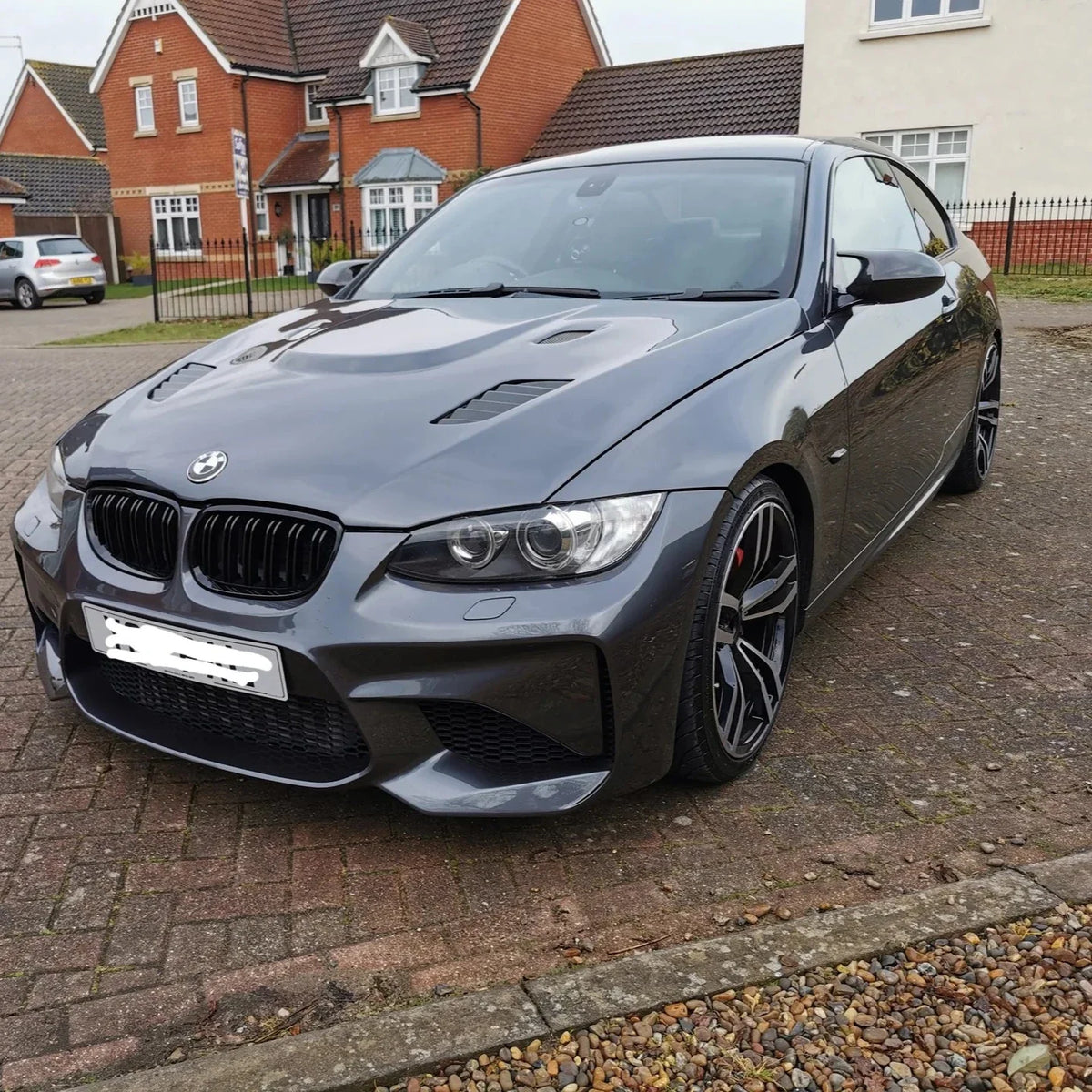 Glossy black ABS M Style mirror caps for BMW E92/E93 328i, 335i, 335is, by Palenon Performance, showing sleek mirror cover design.