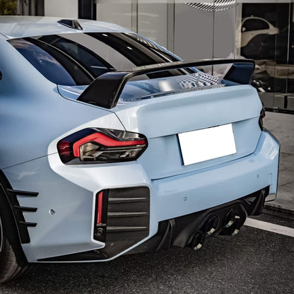 BMW G87 M2 rear side fins diffuser in M Performance style by K2 Industries, showing sleek black design with textured details.