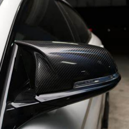 Carbon fiber M style mirror caps for BMW F48 X1 and Palenon Performance CF mirror covers on a BMW F48 vehicle.