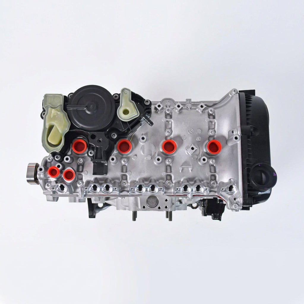 A NEW VW AUDI AUTOMOTIVE engine assembly with a silver cast metal body, black internal components, and a prominent orange and white logo overlay on the side, isolated on a white background.