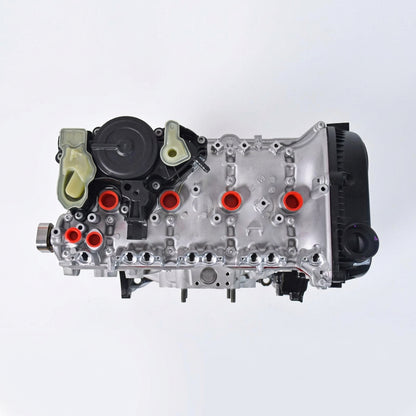 A NEW VW AUDI AUTOMOTIVE engine assembly with a silver cast metal body, black internal components, and a prominent orange and white logo overlay on the side, isolated on a white background.