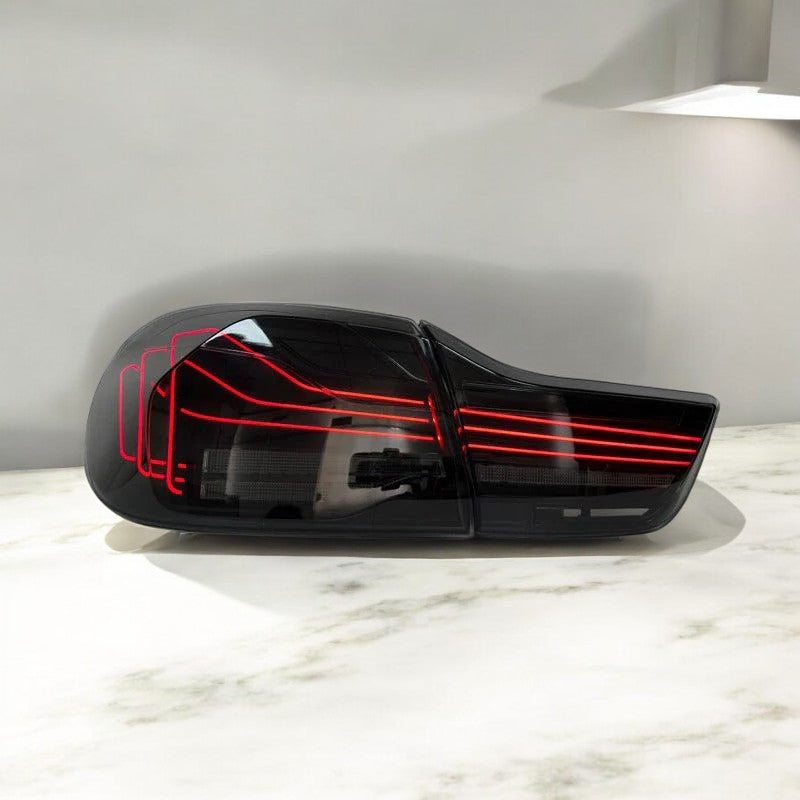 BMW F82 M4 and F32 4 Series CSL-style laser tail lights by Palenon Performance, showcasing sleek red and clear LED taillight design.