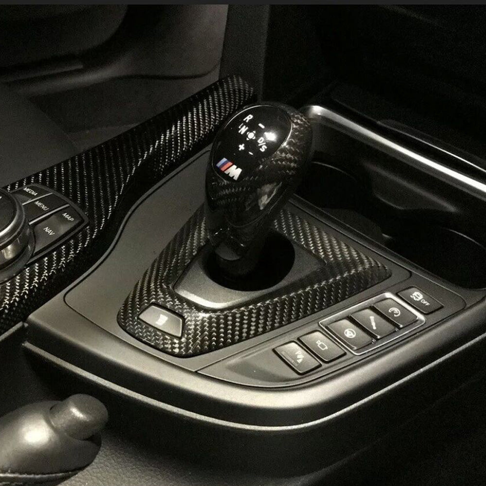 Carbon fiber gear surround trims for BMW F80 M3 and F82/F83 M4 interior, showcasing sleek, textured finish by Palenon Performance.
