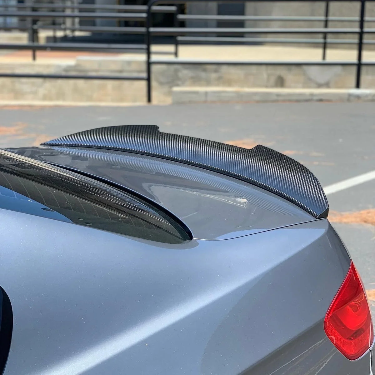 Carbon fiber BMW E93 PSM trunk spoiler by Palenon Performance, showing sleek aerodynamic design on a coupe.