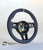 Yellow PDK Porsche 991.2 steering wheel by Boston Motortech, showing close-up of textured leather grip and sleek design.