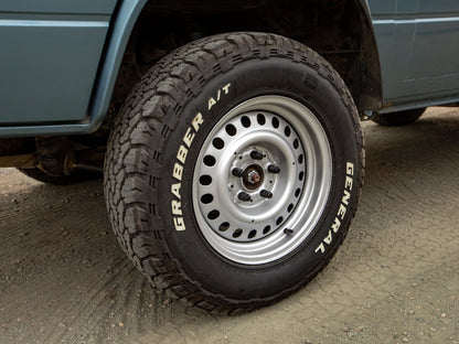 GoWesty 15-inch steel wheel set for 2WD and 4WD Bus and Vanagon vehicles, shown installed on a vehicle.