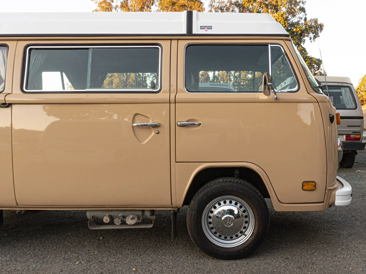 15-inch silver steel wheel for Bus and Vanagon by GoWesty, suitable for 2WD and 4WD vehicles, shown on vehicle.