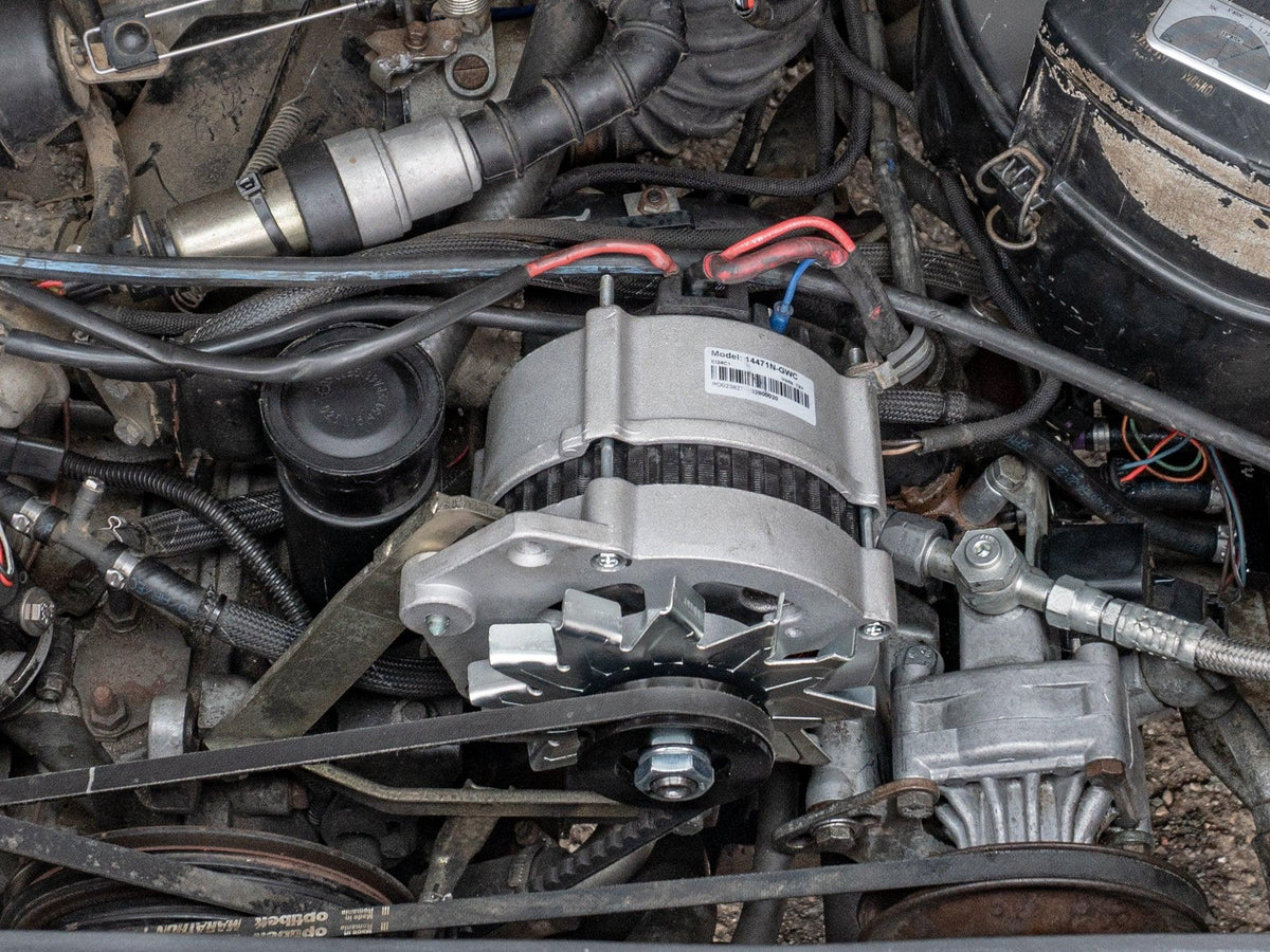 GoWesty 90A water-cooled alternator for Vanagon, showing the alternator installed with cooling components and wiring.