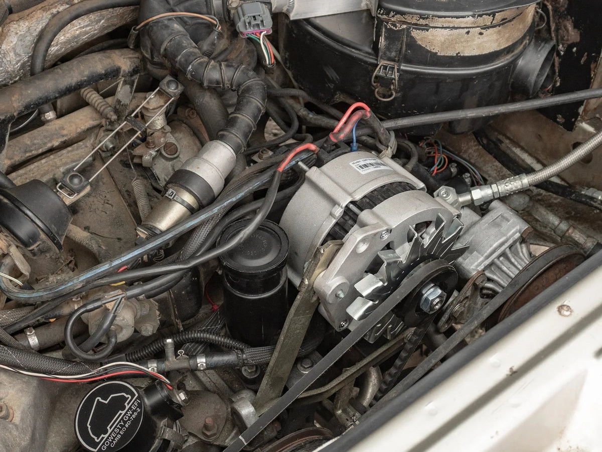 Watercooled Vanagon 90A alternator by GoWesty, shown installed with cooling components and wiring.