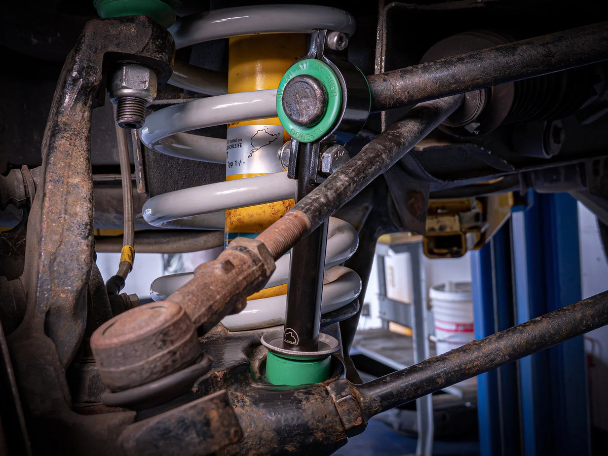 GoWesty front sway bar bushing bundle installed on a Vanagon, showing the bushings and suspension components in a vehicle undercarriage.