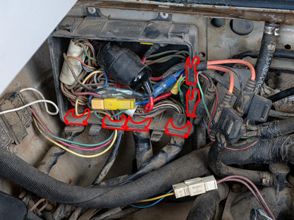 GoWesty Grommet Set for Vanagon junction and relay boxes, showing electrical grommets and accessories in a workshop setting.